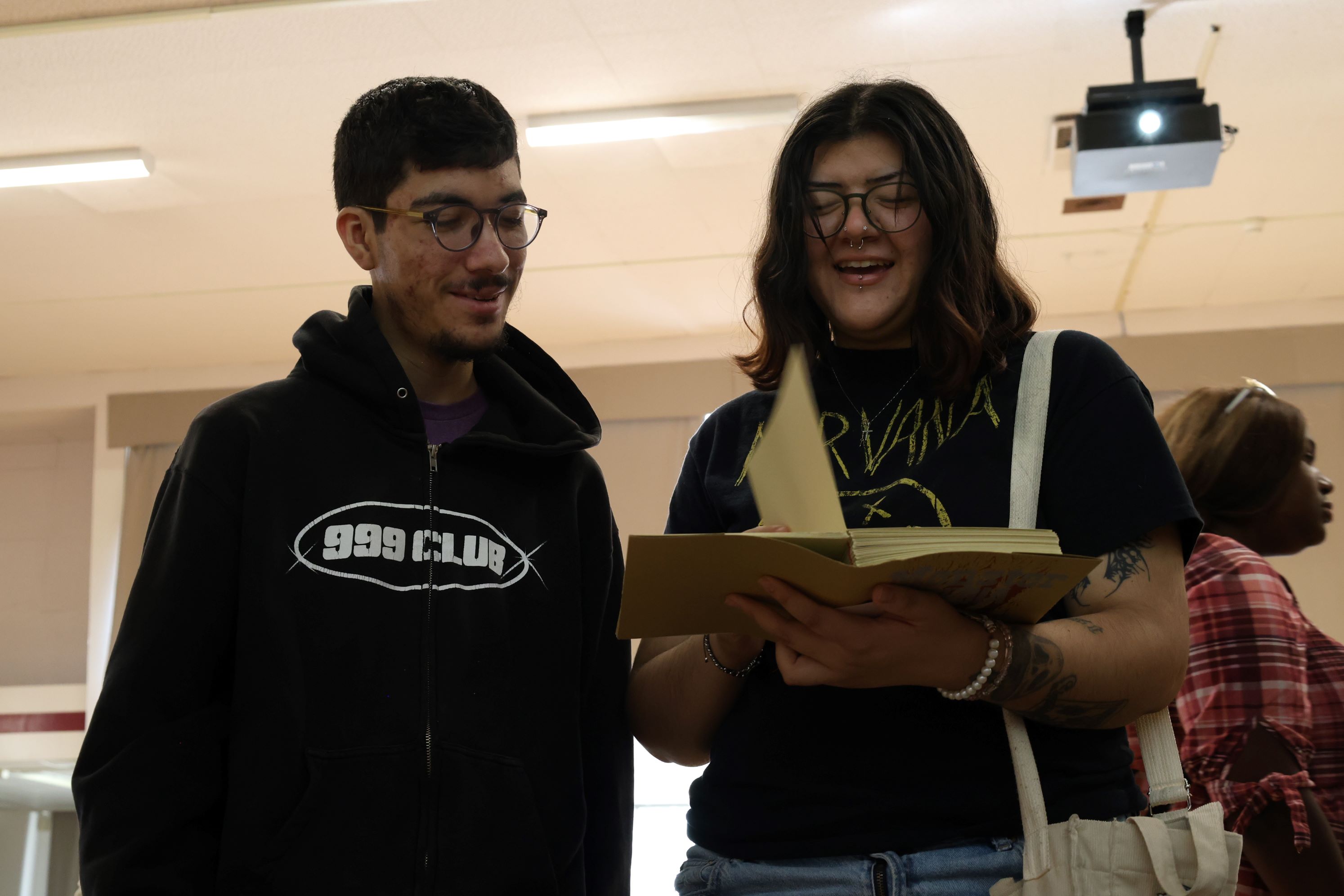 Two students exploring a book